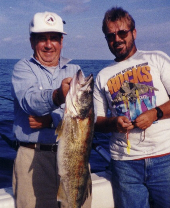 Two men showing off a caught fish